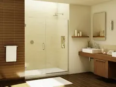 Frameless glass shower door in a warm, modern bathroom with wood vanity