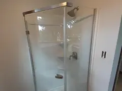 Newly installed frameless glass shower enclosure