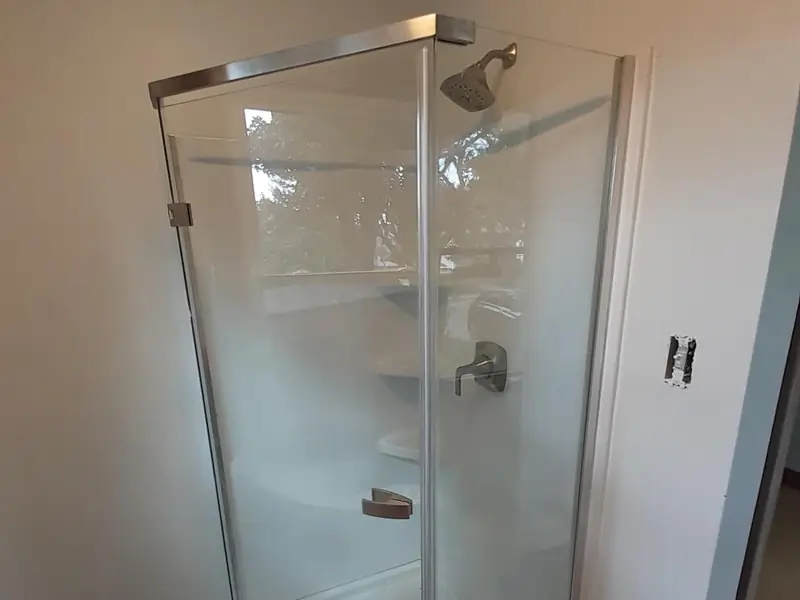 Newly installed frameless glass shower enclosure